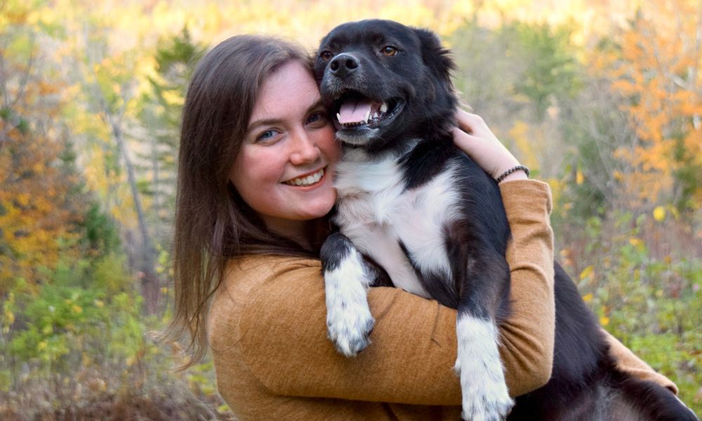 Woman with dog holding her arms around the dog